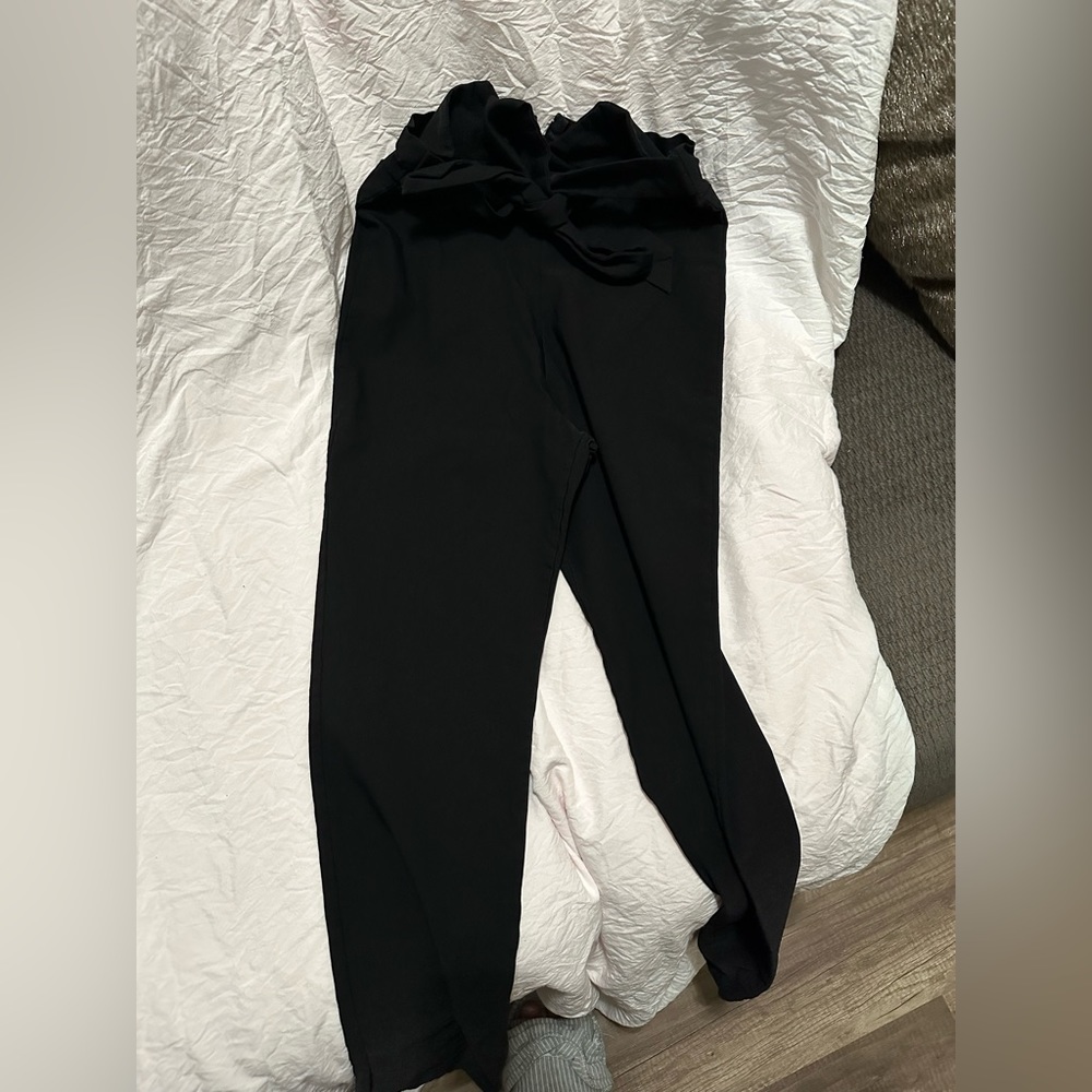 The brand is love tree. Black pants with a bow you can put in the front and back